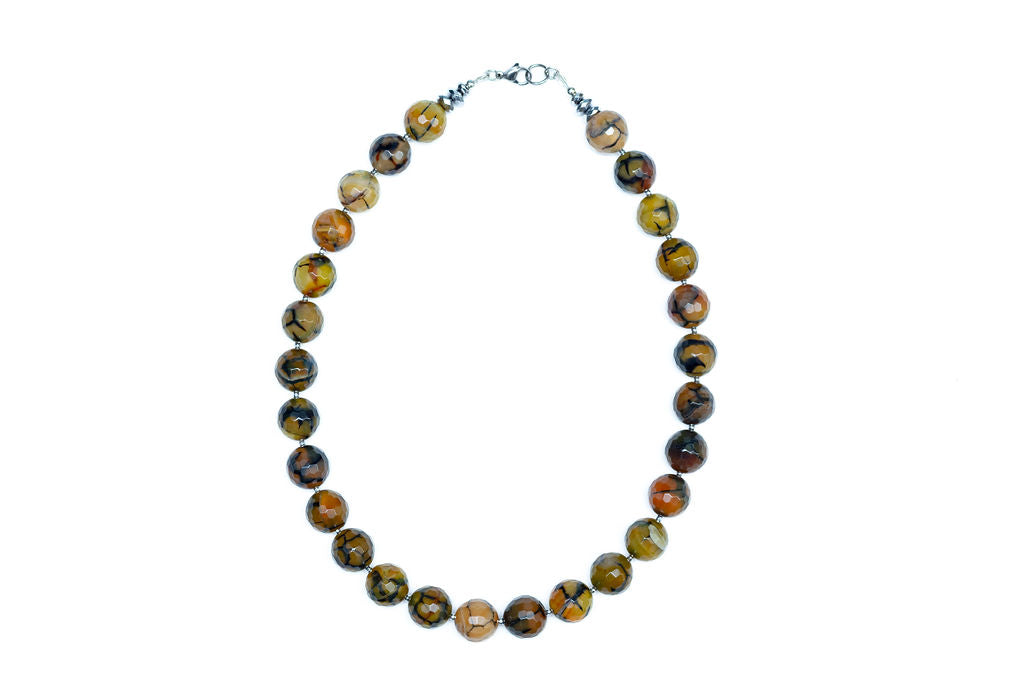 A beaded necklace with a stainless steel lobster clasp, featuring a variety of colored beads against a white background.