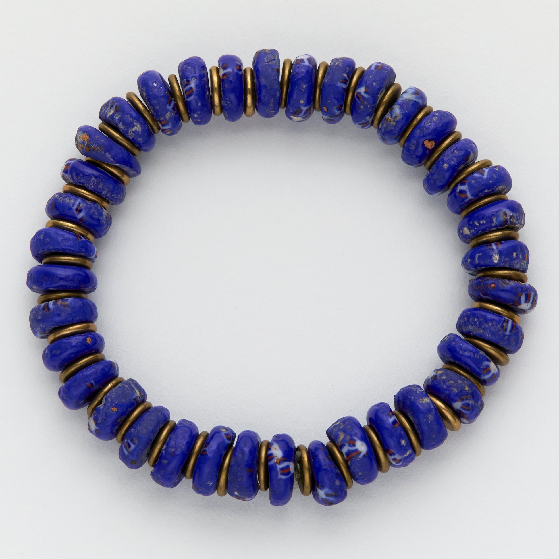 Blue beaded bracelet with gold accents on a white background