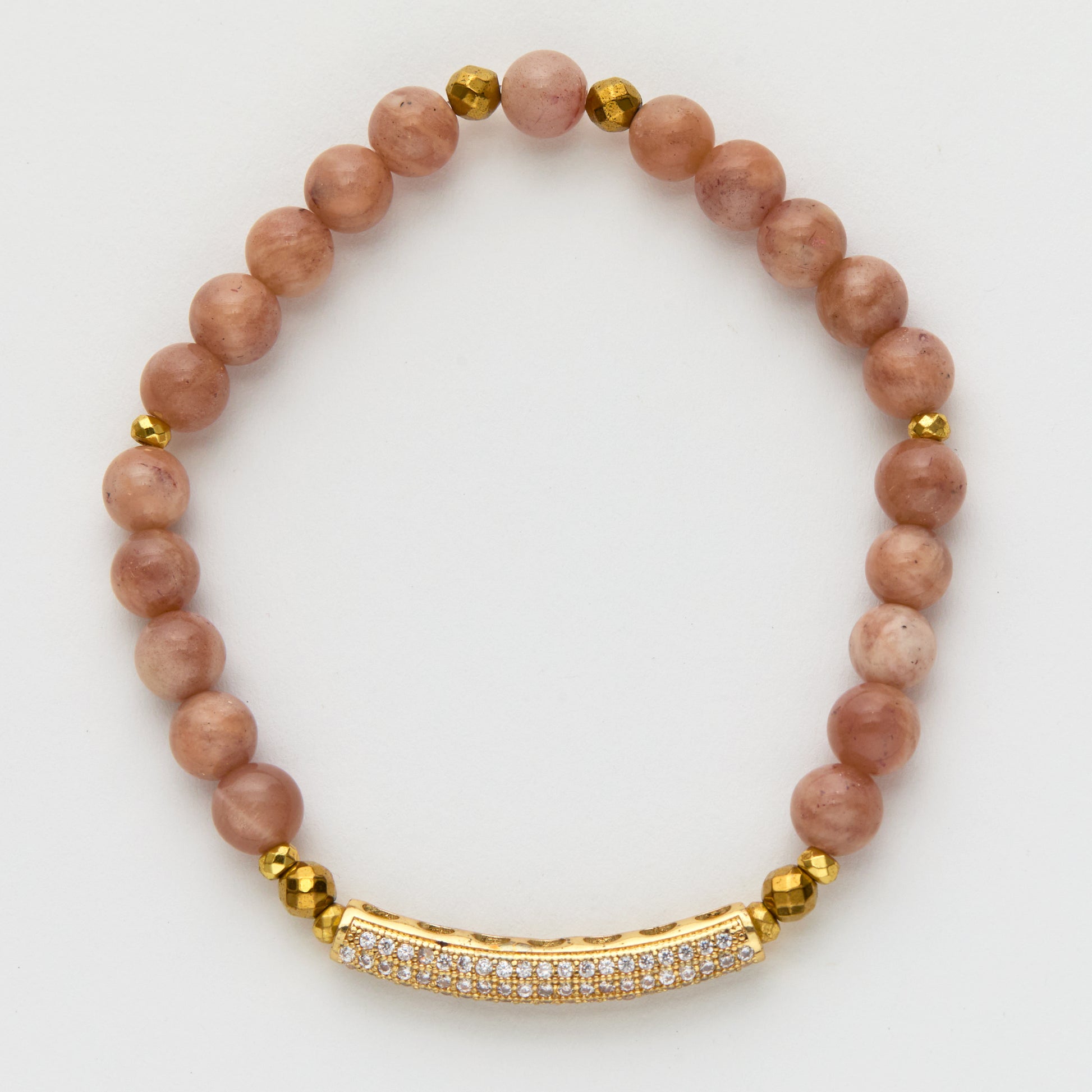 Bracelet with pink beads and gold accents on a white background