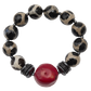 Bracelet with black and white patterned beads and a red central bead on a white background