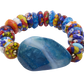 Colorful beaded bracelet with a large blue stone on a white background
