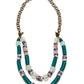 Beaded necklace with green, pink, and white beads on a white background