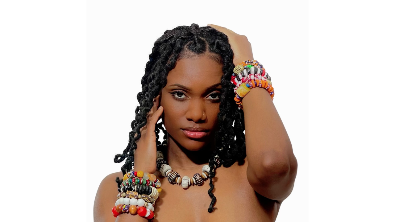 Black woman wearing assorted jewelry made with African recycled glass beads.