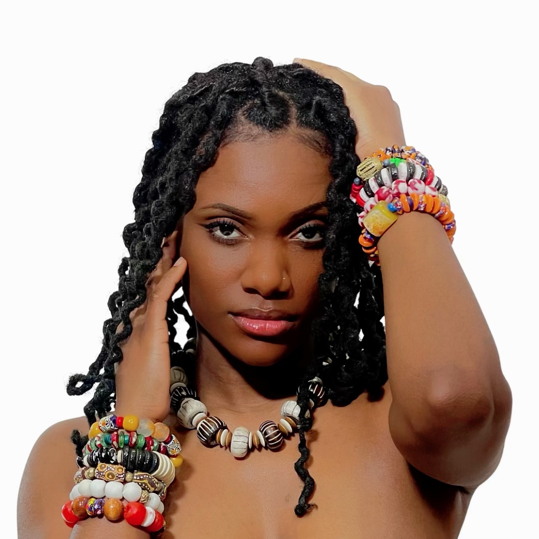Black woman wearing an assortment of colorful African bead bracelets
