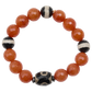 Beaded bracelet with orange beads and black and white patterned beads on a white background