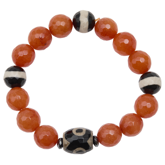 Beaded bracelet with orange beads and black and white patterned beads on a white background
