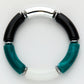 Bracelet with black and teal cylindrical beads on a white background