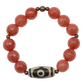 Bracelet with red beads and a brown and white central bead on a white background