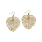 Brass monstera leaf-shaped earrings on a white background