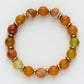 Beaded bracelet with orange, yellow, and red beads on a white background