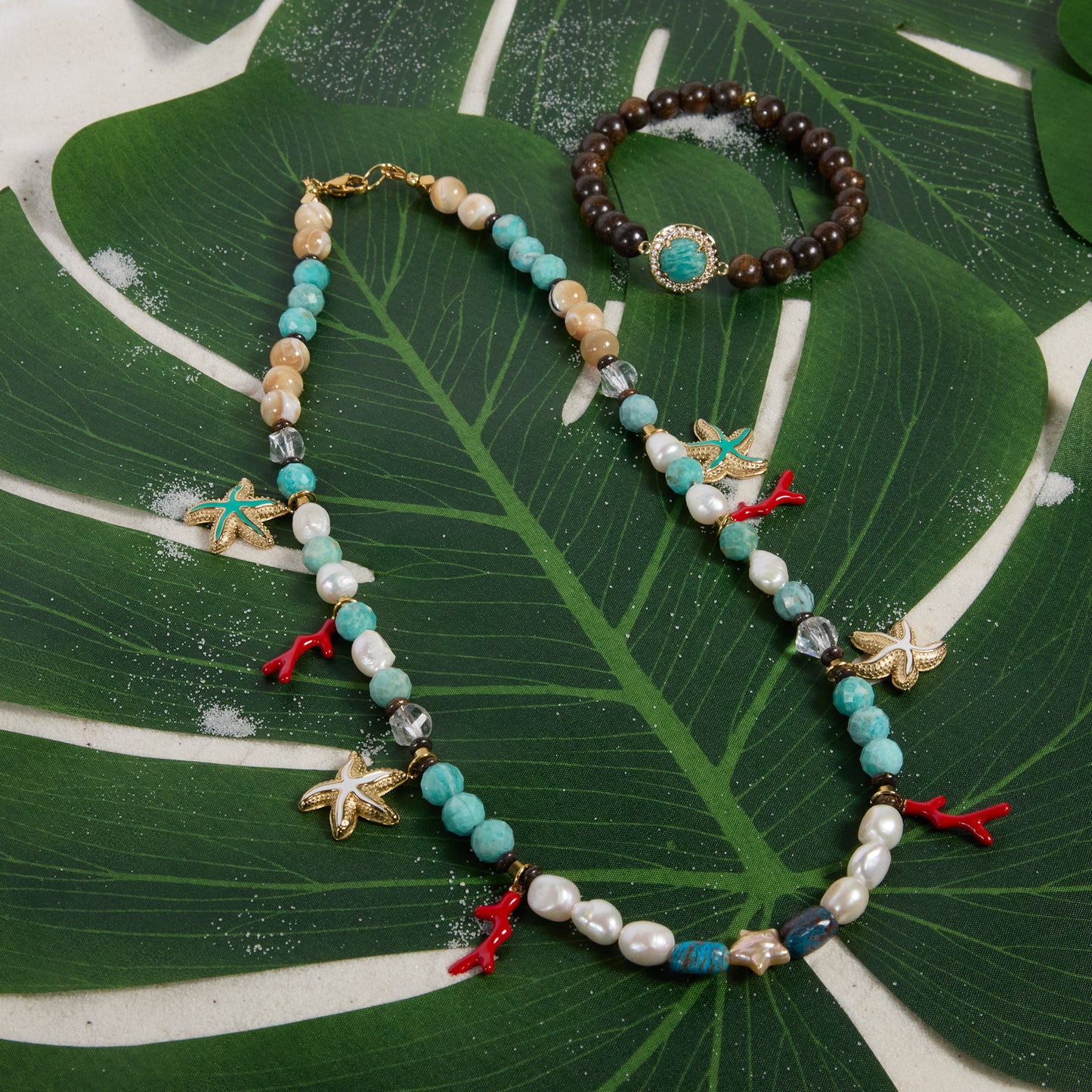 Necklace and bracelet set on a large green leaf