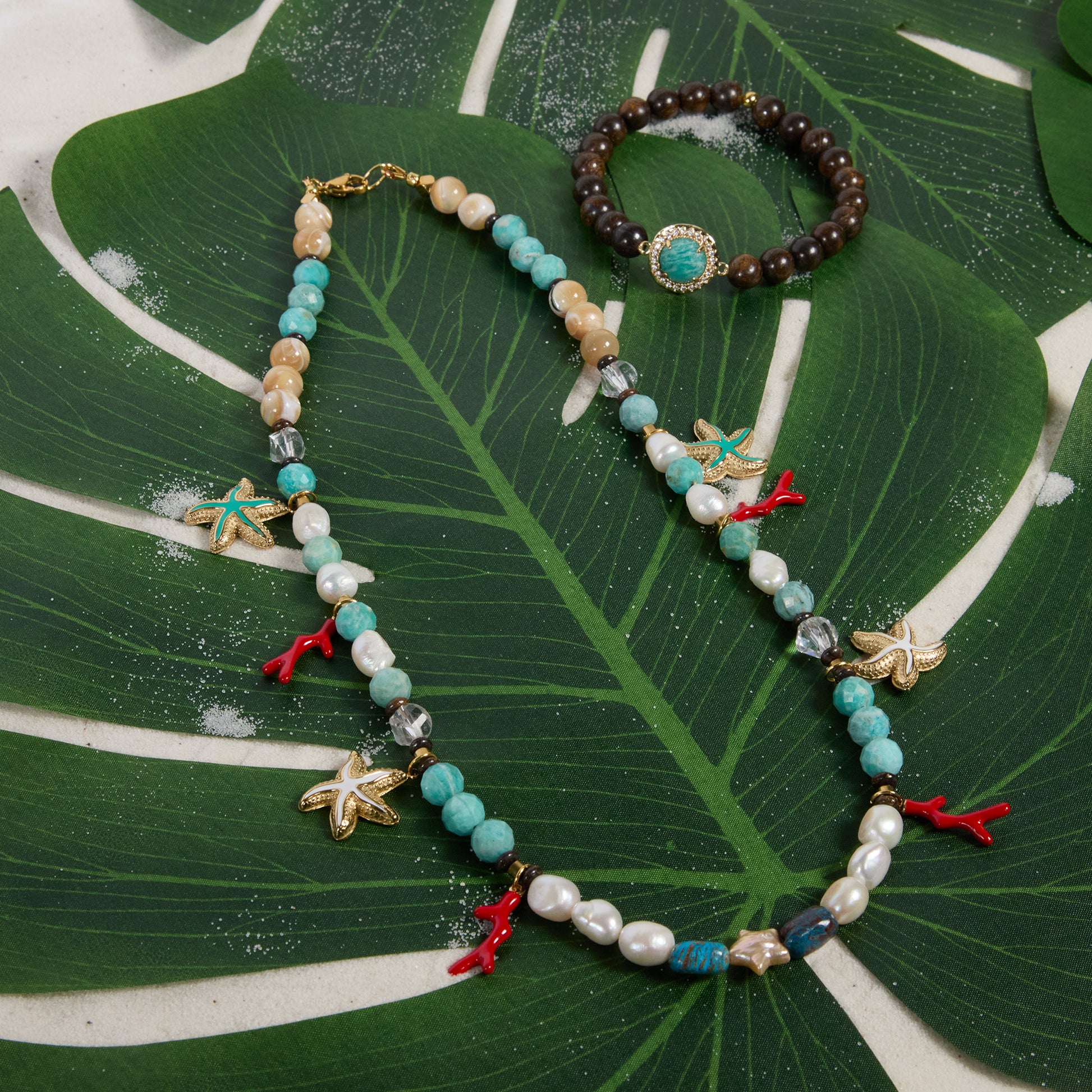 Necklace and bracelet set on a large green leaf