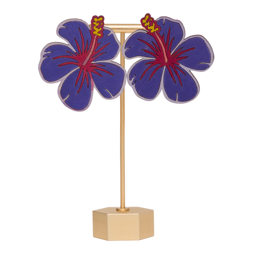 Hand-painted purple hibiscus flower earrings on a gold stand on a white background