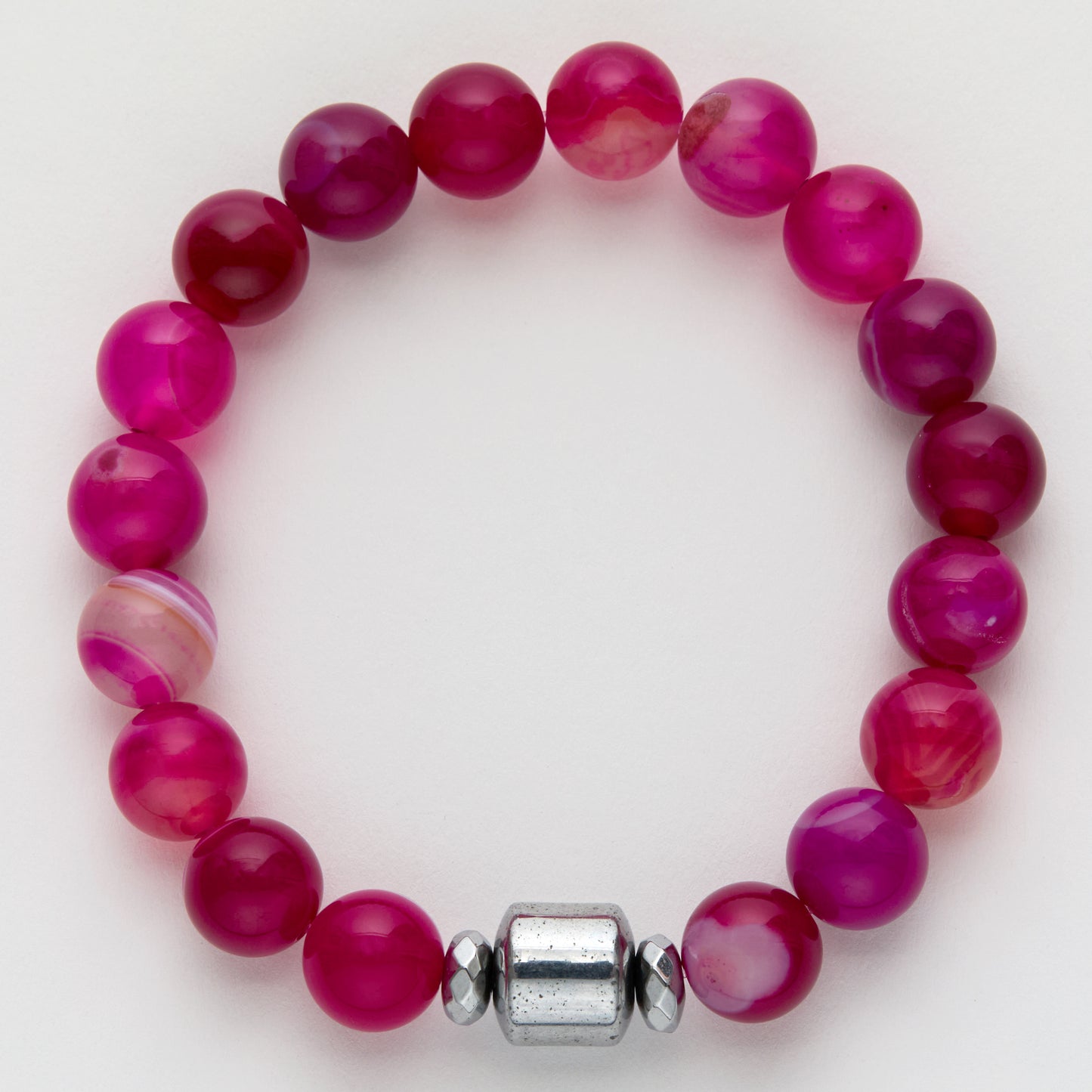 Pink beaded bracelet with a silver clasp on a white background