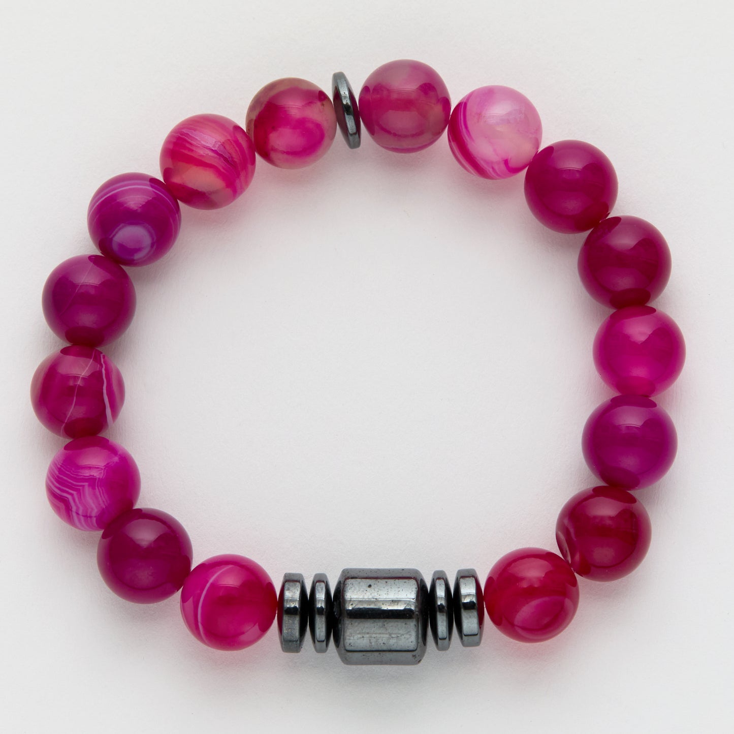 Pink beaded bracelet with a silver clasp on a white background