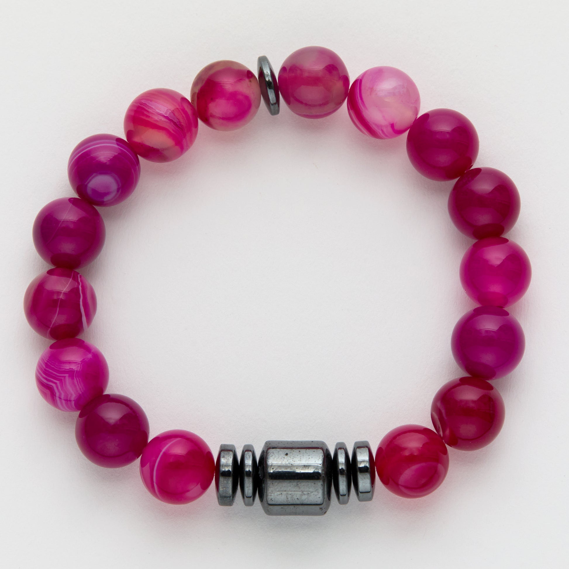 Pink beaded bracelet with a silver clasp on a white background