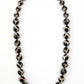 Necklace with black and white patterned beads on a white background