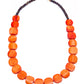 Necklace with orange beads and a gold clasp on a white background
