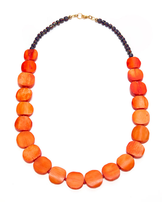 Necklace with orange beads and a gold clasp on a white background