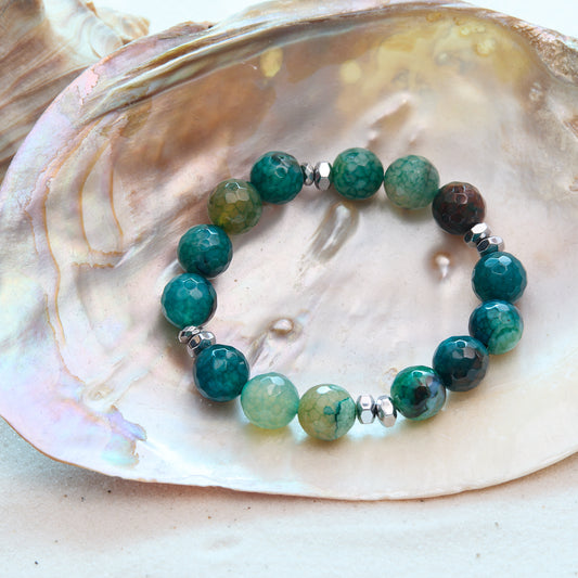 Green beaded bracelet on a large shell