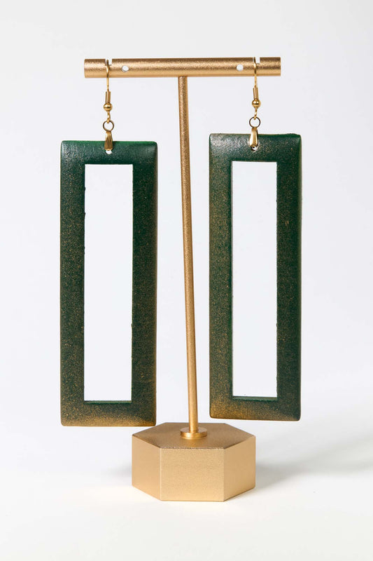 Green open rectangle earrings on a gold stand against a white background