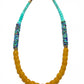 Necklace with yellow beads and multicolored accents on a white background